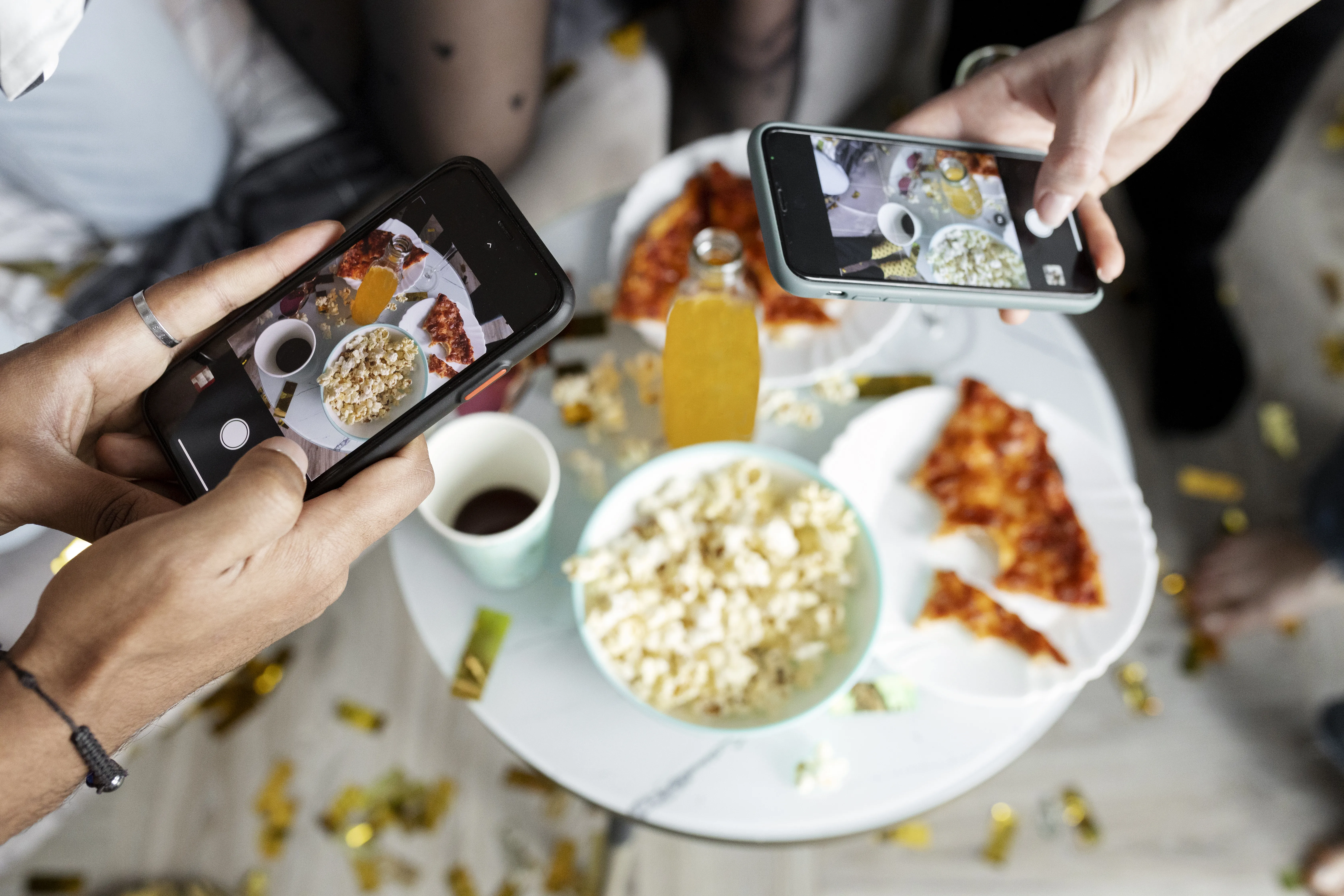 High angle friends taking food photos with smartphones
